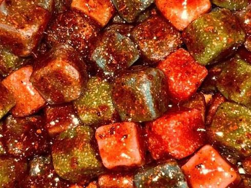 Chamoy candy, with a bright red spicy sauce on the outside, is sweet and sour